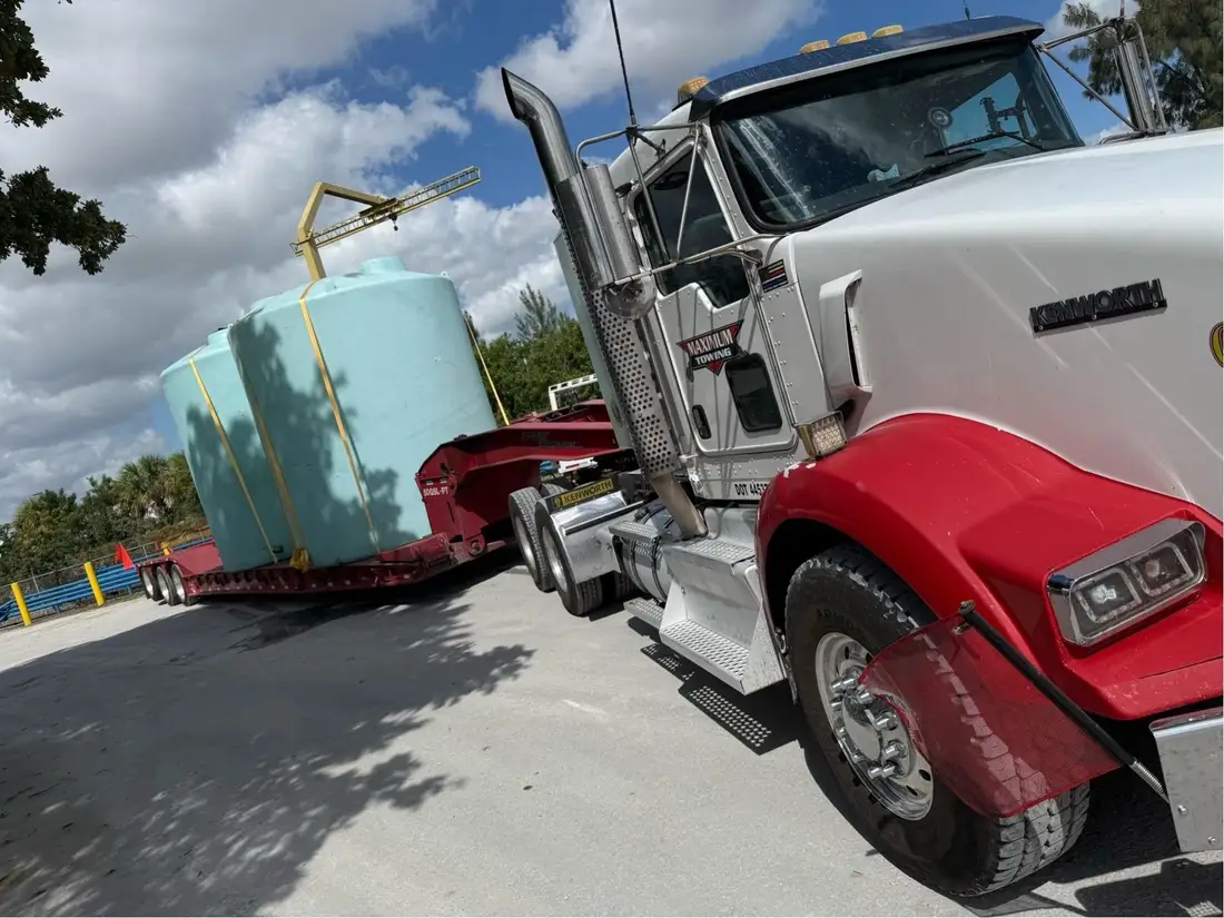 Oversized tank secured on a lowboy trailer
